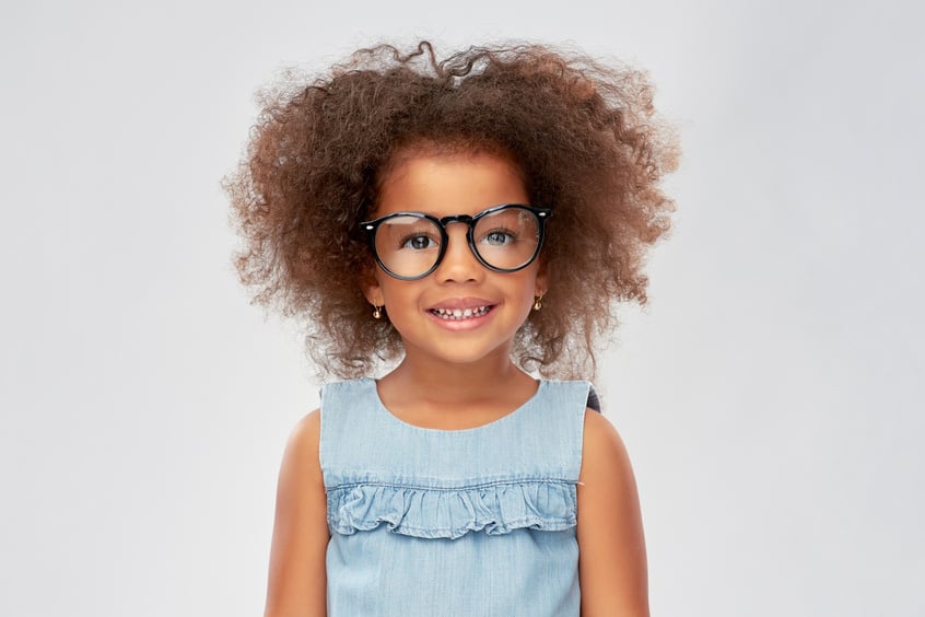 Portrait of a Smiling Little Girl with Eyeglasses